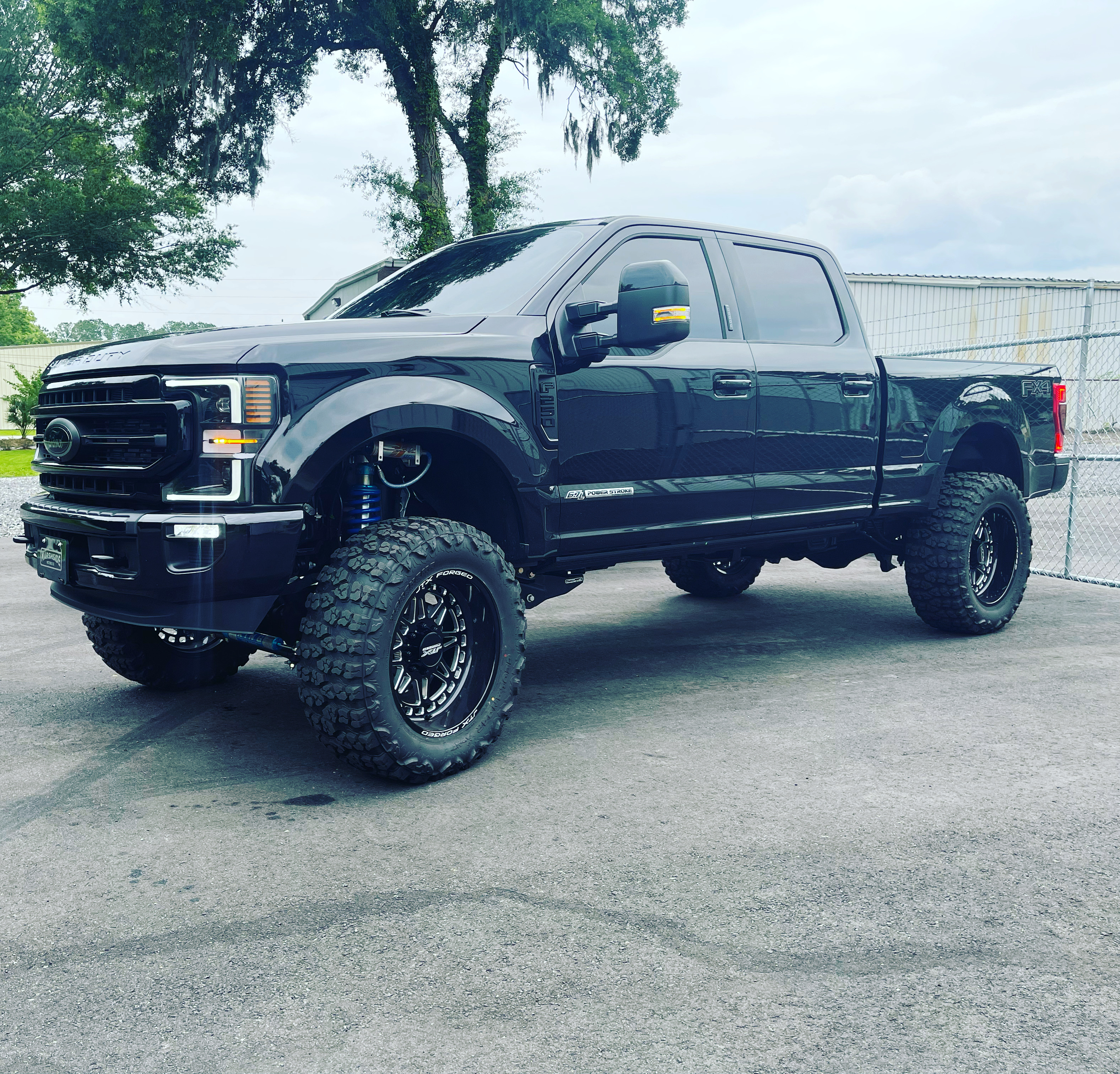 Lifted black Ford F250 with custom suspension